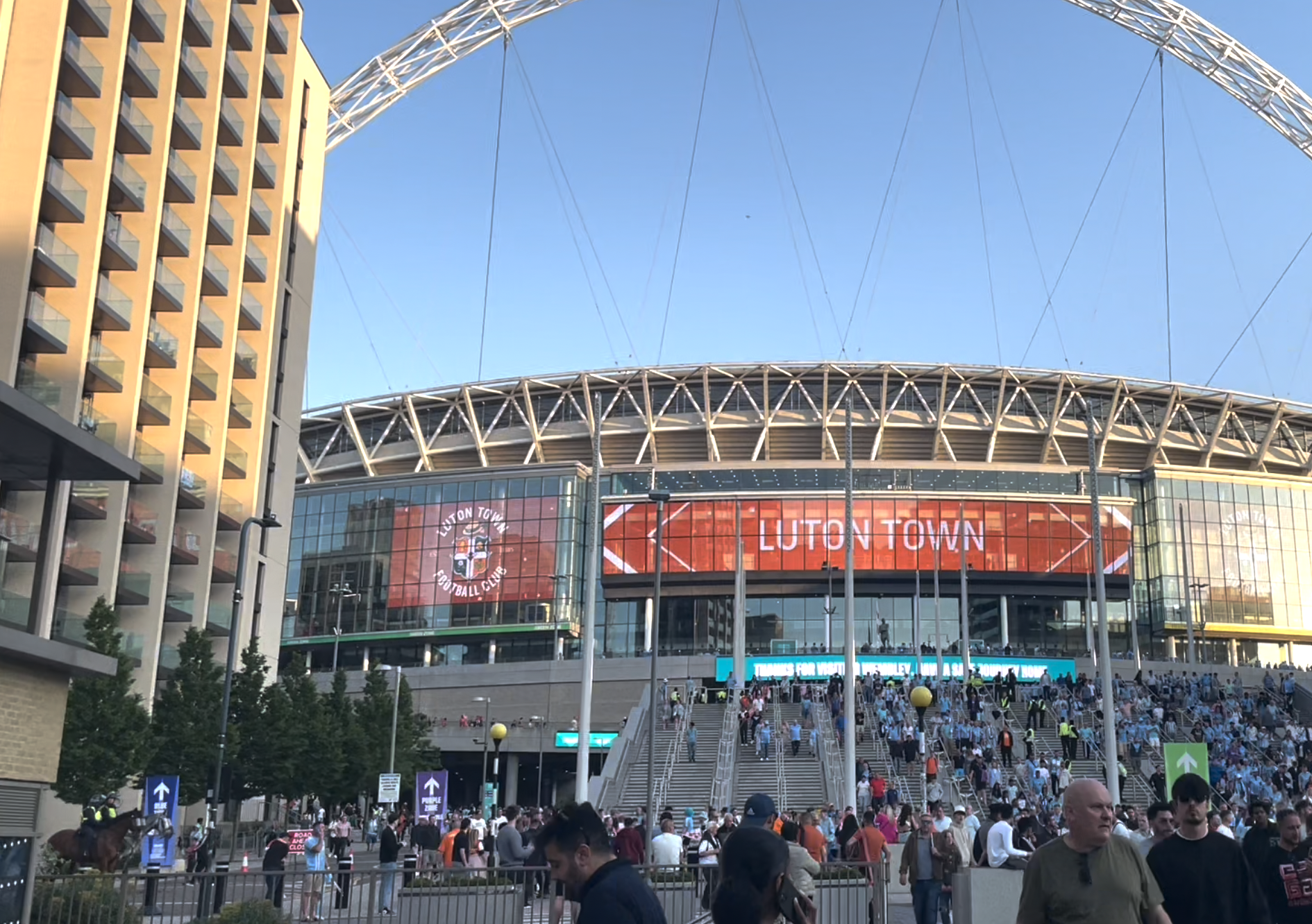 Football stadium with 'Luton Town' written outside on digital boards.